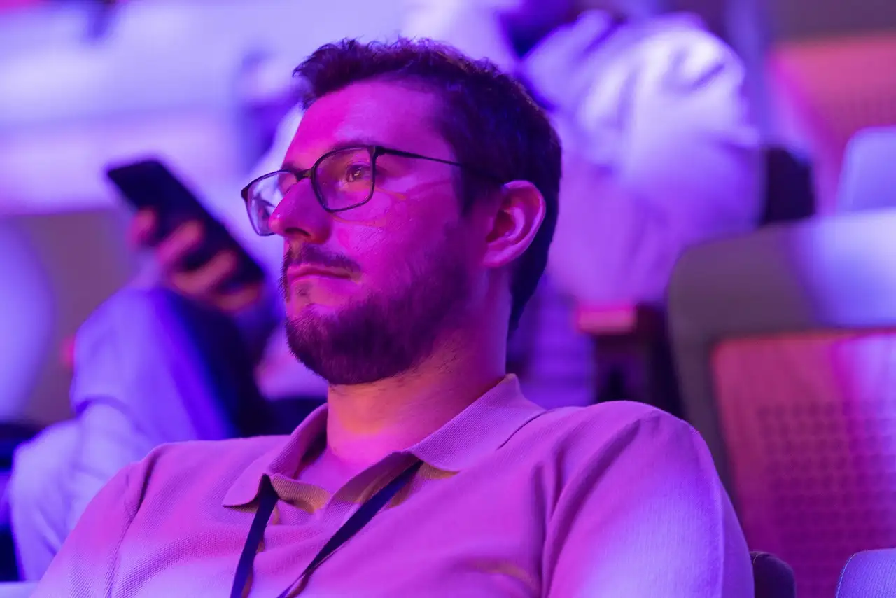 An attendee listening in the auditorium